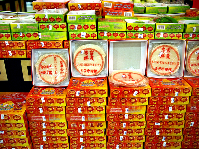 Dozens of tikoy boxes stacked on top of each other.