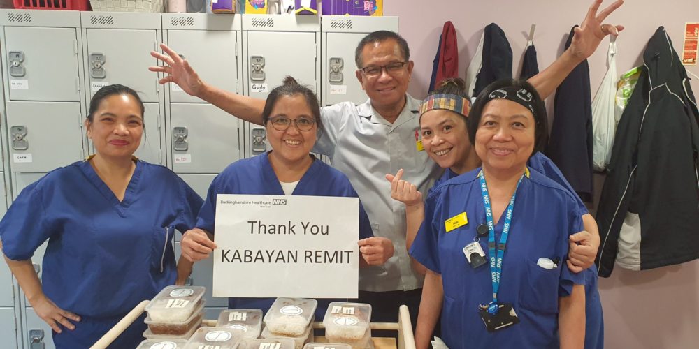 Nurses happily holding up a "thank you Kabayan Remit" sign.