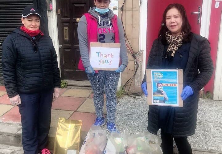 three nurses with bags of food and two nurses holding thank you signs