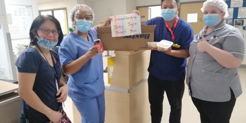 four nurses proudly holding food from Kabayan Remit